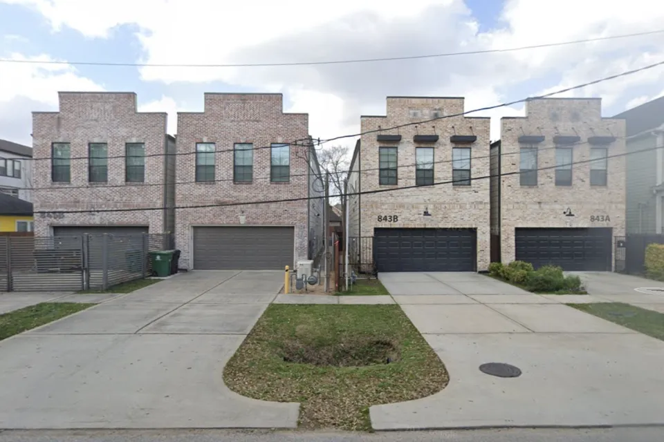 Two-story split lot housing in Houston, Texas with two-car garages
